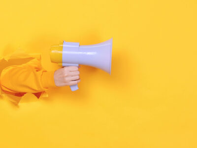 Woman,Hand,Arm,Hold,Megaphone,Isolated,Through,Torn,Yellow,Background